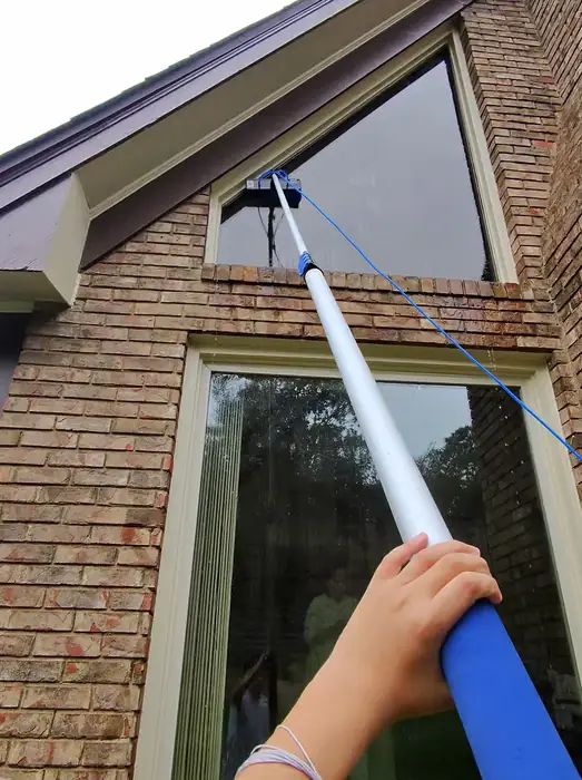 Reaching a high gable window with a water fed pole
