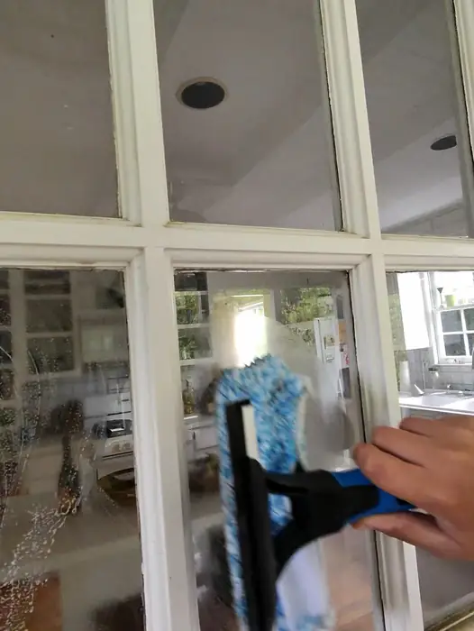 Cleaning interior French door glass by hand