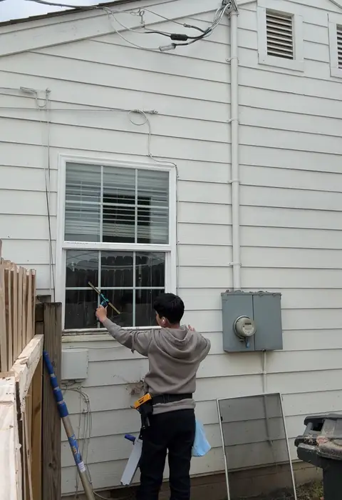 Crew member cleaning a side window by hand