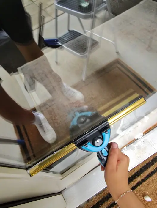 Step 3, Squeegee: Squeegee detailing a glass door